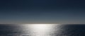 Abstract panorama view of ocean water with glistening sunlight and orange and blue sky Royalty Free Stock Photo