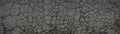 Abstract panoramic background. Monochrome texture of cracked asphalt