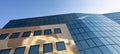 Facade of modern office building in glass and steel with reflections of blue sky Royalty Free Stock Photo