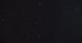 Abstract particles flying over black background