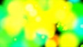 Abstract particles of green, yellow, red, blue, blue colors in the form of blurred spots of different diameters on a black