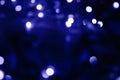 Abstract pattern of blue bokeh lights on a dark background Royalty Free Stock Photo