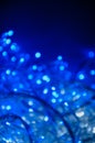 Abstract pattern bokeh blue lights of garland on a dark background Royalty Free Stock Photo