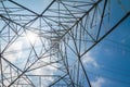 Abstract pattern from bottom view of high voltage pole power transmission tower clear sky in sunshine day background Royalty Free Stock Photo