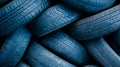 Abstract pattern created by a stack of worn blue tires, showcasing the texture and wear of discarded rubber Royalty Free Stock Photo