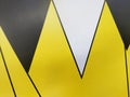 An abstract pattern features sharp, overlapping yellow and black triangles Royalty Free Stock Photo