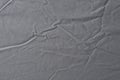Abstract pattern of a gray crumpled bed sheet in bedroom. Gray wrinkled fabric texture rippled surface, Close up bed sheet in the