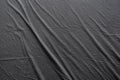 Abstract pattern of a gray crumpled bed sheet in bedroom. Gray wrinkled fabric texture rippled surface, Close up bed sheet in the