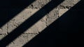 Abstract pattern of light and shadow on a textured concrete wall surface Royalty Free Stock Photo