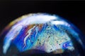 Abstract pattern, multicolored chaotic texture inside of the soap bubble, closeup