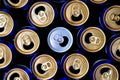 Abstract pattern of opened aluminium cans, top view. One white soda or beer can standing out among yellow and blue cans. Royalty Free Stock Photo