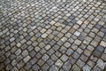 Abstract pattern of squared old-fashioned simple rough gray concrete street cobblestone pavement. Construction, decoration and ba