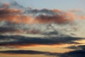 Abstract pattern sunset colored and darker clouds