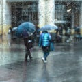 Abstract people under the umbrella, rainy weather, blurred motion. View through glass window with rain drops on glass Royalty Free Stock Photo