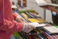 Abstract person in disposable protective gloves with book in hands, library, bookstore. New normal. Risk area for spreading