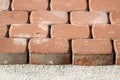 Brown concrete permeable flooring assembled on a substrate of sand. Abstract photo of bricks in the sunlight