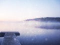 Abstract photo of misty and foggy lake at morning sunrise. Royalty Free Stock Photo