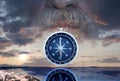 Abstract photo of part of face of man with compass against the sunset