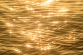 Abstract photo of surface water of sea or ocean at sunset time with golden light tone. Royalty Free Stock Photo