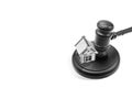Abstract photo with wooden gavel and abstract house isolated on white background as symbol of sale of mortgage or emergency housin Royalty Free Stock Photo