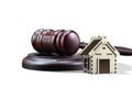 Abstract photo with wooden gavel and abstract house isolated on white backgroundas symbol of sale of mortgage or emergency housing