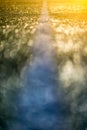 Abstract photograph of football pitch. Colorful background with artificial turf covered with dew in early morning light