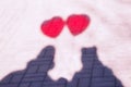 Abstract picture: shadow of couple in love with two red air balloons shaped like hearts. Romance concept Royalty Free Stock Photo