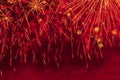 Abstract picturesque background of festive firework in red color, glowing sparks and stars