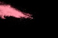 Abstract pink dust explosion on black background. Royalty Free Stock Photo