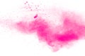 Abstract pink dust explosion on white background.  Freeze motion of pink powder splash Royalty Free Stock Photo