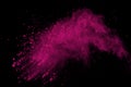 Freeze motion of colored powder explosion isolated on black background. Abstract of Multicolor dust splatted.