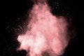 Abstract pink powder explosion on black background. Freeze motion of light pink dust splashing Royalty Free Stock Photo