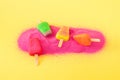 Abstract pink sand with colored ice cream on yellow background. Minimal summer sunny day concept. Beach vacation idea