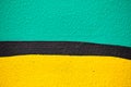 Abstract plaster texture of green, yellow with a black stripe of color Royalty Free Stock Photo