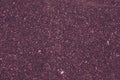 Abstract purple background of small pebbles, asphalt surface. Pink pattern of granite stone. Art design, tinsel, sparkles. Texture Royalty Free Stock Photo