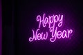Abstract purple colored lifht bright neon text Happy New Year Royalty Free Stock Photo
