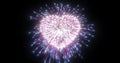 Abstract purple pink fireworks festive fireworks for valentine`s day in the shape of a heart from glowing particles and magical Royalty Free Stock Photo