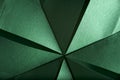 Abstract radial green background of textured paper folded using origami