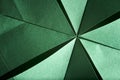 Abstract radial green background of textured paper folded using origami