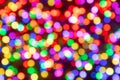 Abstract rainbow colours blurred light circles whith bokeh effect on on a dark background with red shadows Royalty Free Stock Photo