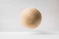 Abstract real wooden sphere with surreal layout on white surface background