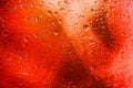 Abstract red background with blurred raindrops on glass, illuminated neon lights. Modern background