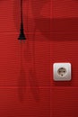 Abstract red background with white socket, black plug, and wire