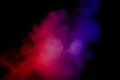 Abstract red blue dust explosion on black background. Royalty Free Stock Photo