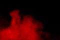 Abstract red dust splattered on black background. Red powder explosion. Royalty Free Stock Photo