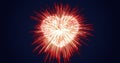 Abstract red fireworks festive fireworks for valentine`s day in the shape of a heart from glowing particles and magical energy Royalty Free Stock Photo