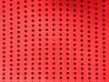 Abstract red perforated plastic bacground Royalty Free Stock Photo