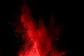 Abstract red powder explosion on black background.abstract red powder splatted on black background. Freeze motion of red powder ex Royalty Free Stock Photo