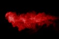 Abstract red powder explosion on black background.abstract red powder splatted on black background. Freeze motion of red powder