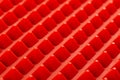 Abstract red silicone pyramids array close-up background